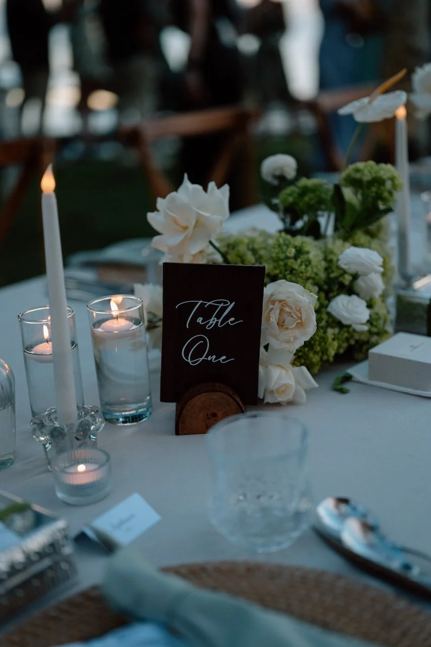 Table number one sign with white roses at a destination wedding reception.