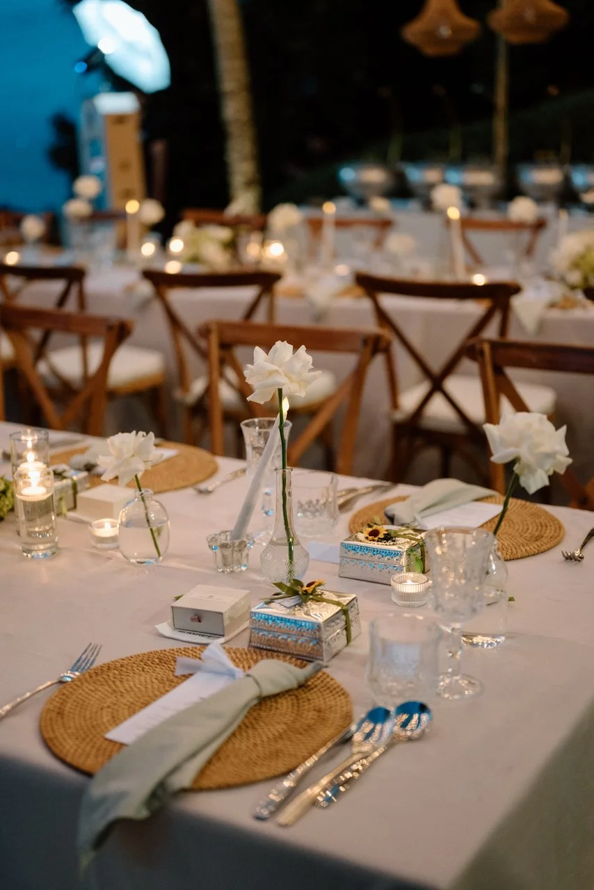 Villa Pemutih wedding reception table setting with long-stemmed white flowers.