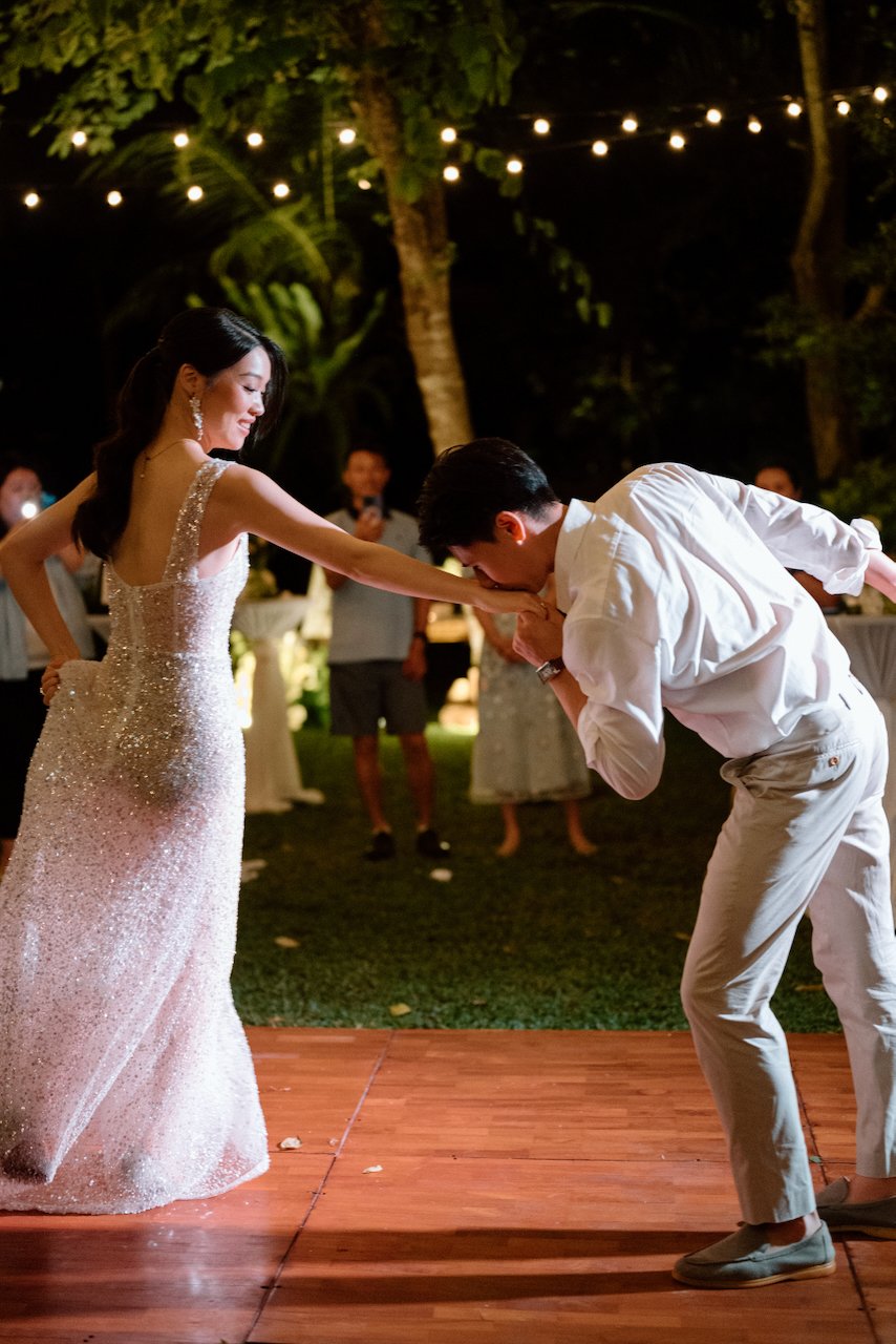 Groom dipping the bride on the dance floor during their Bali reception.
