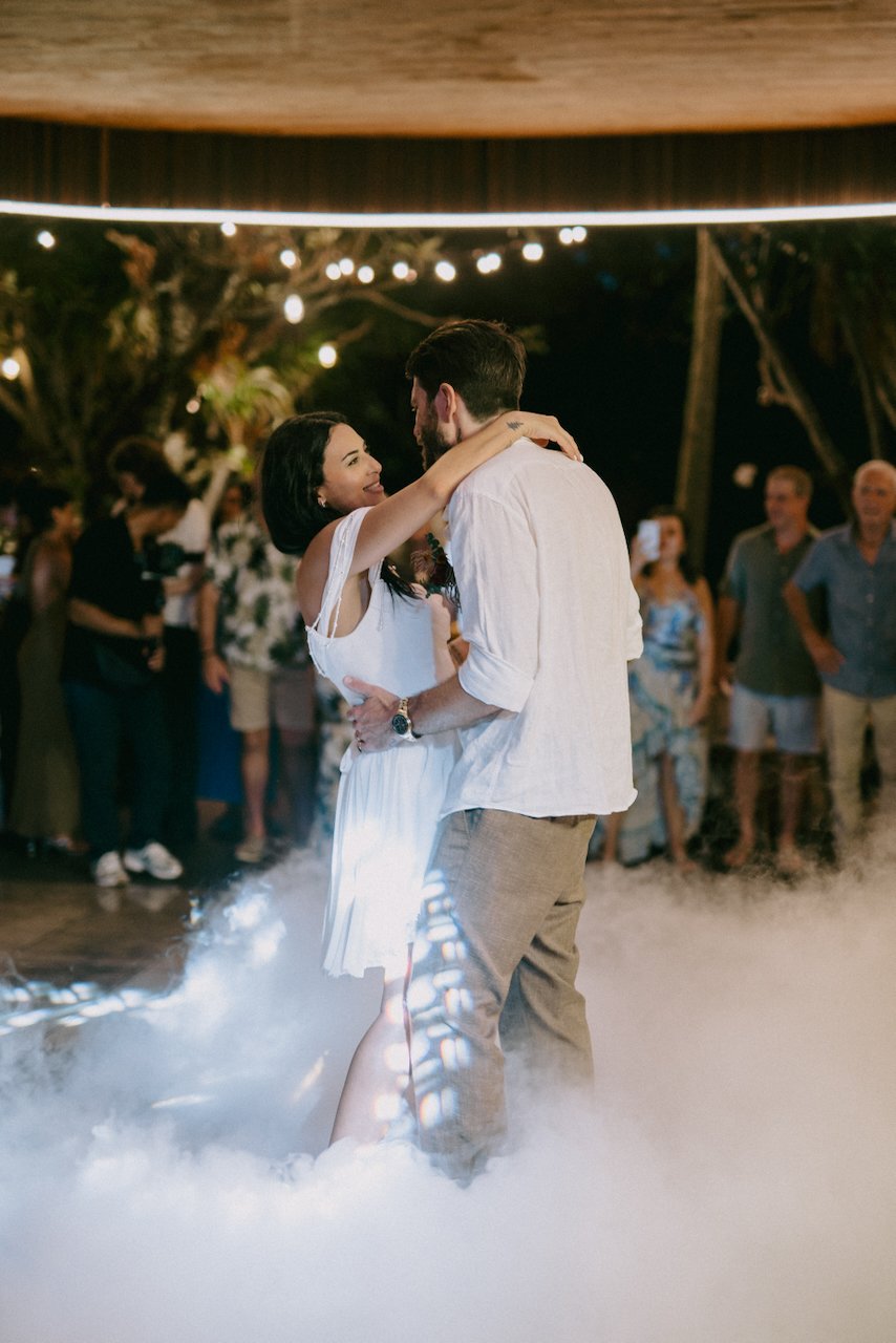 Emily and Tom sharing their first dance beneath the fairy lights.