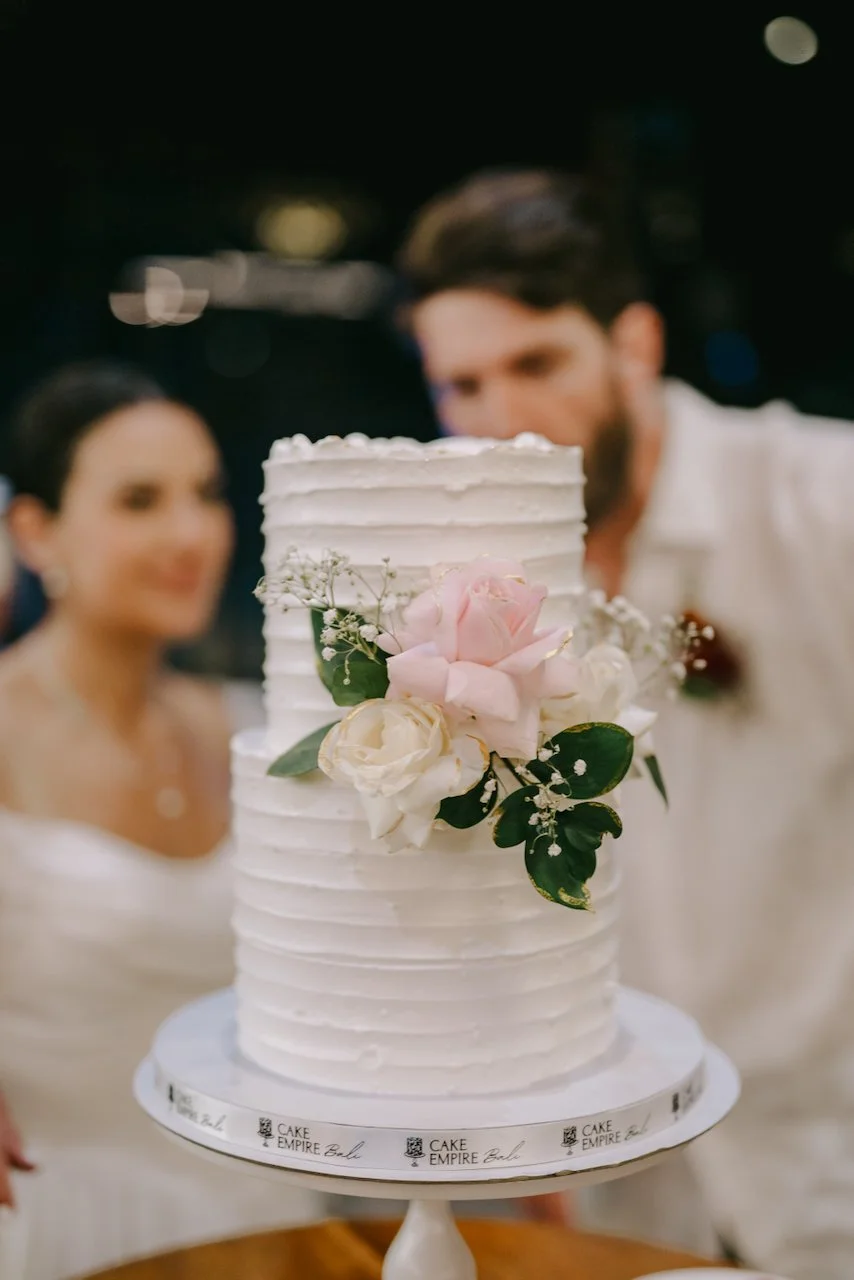 Buttercream wedding cake decorated with fresh flowers.