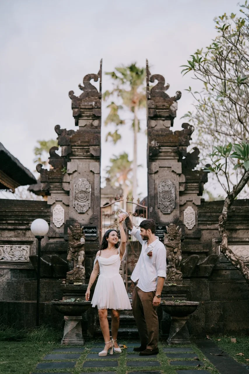Emily and Tom photographed at a traditional Balinese temple after their ceremony.