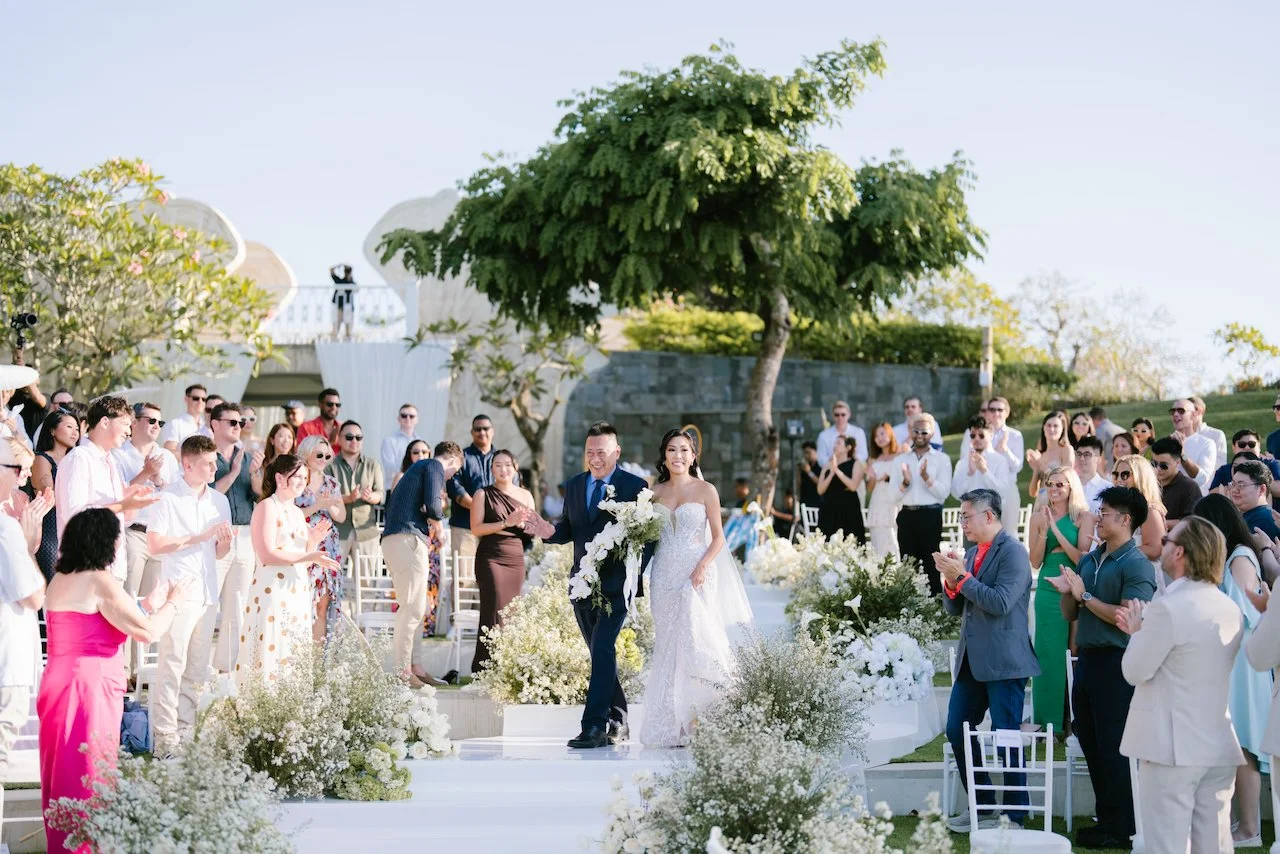 Wide view of the outdoor wedding ceremony with guests watching Thomas and Zoe at the altar