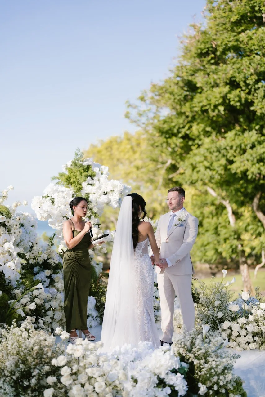Standing at the oceanfront altar during Thomas and Zoe's wedding ceremony