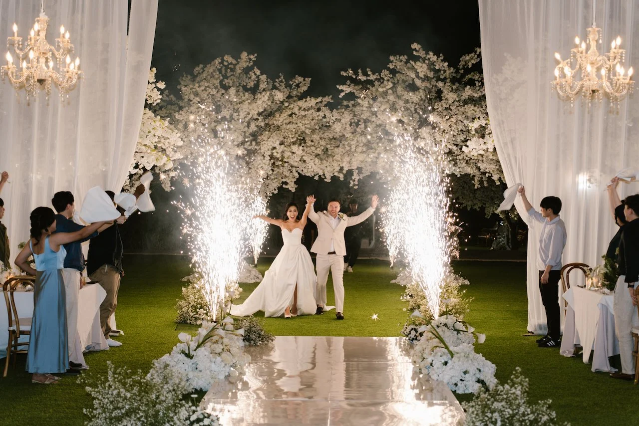 Bride and groom making their grand reception entrance surrounded by cold sparkler fountains