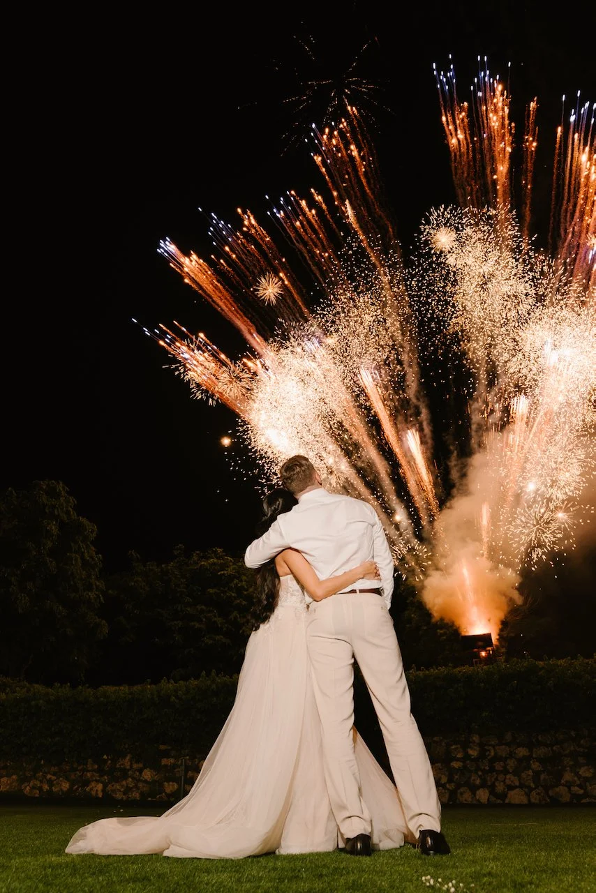Vibrant fireworks display lighting up the night sky over the outdoor Bali wedding reception