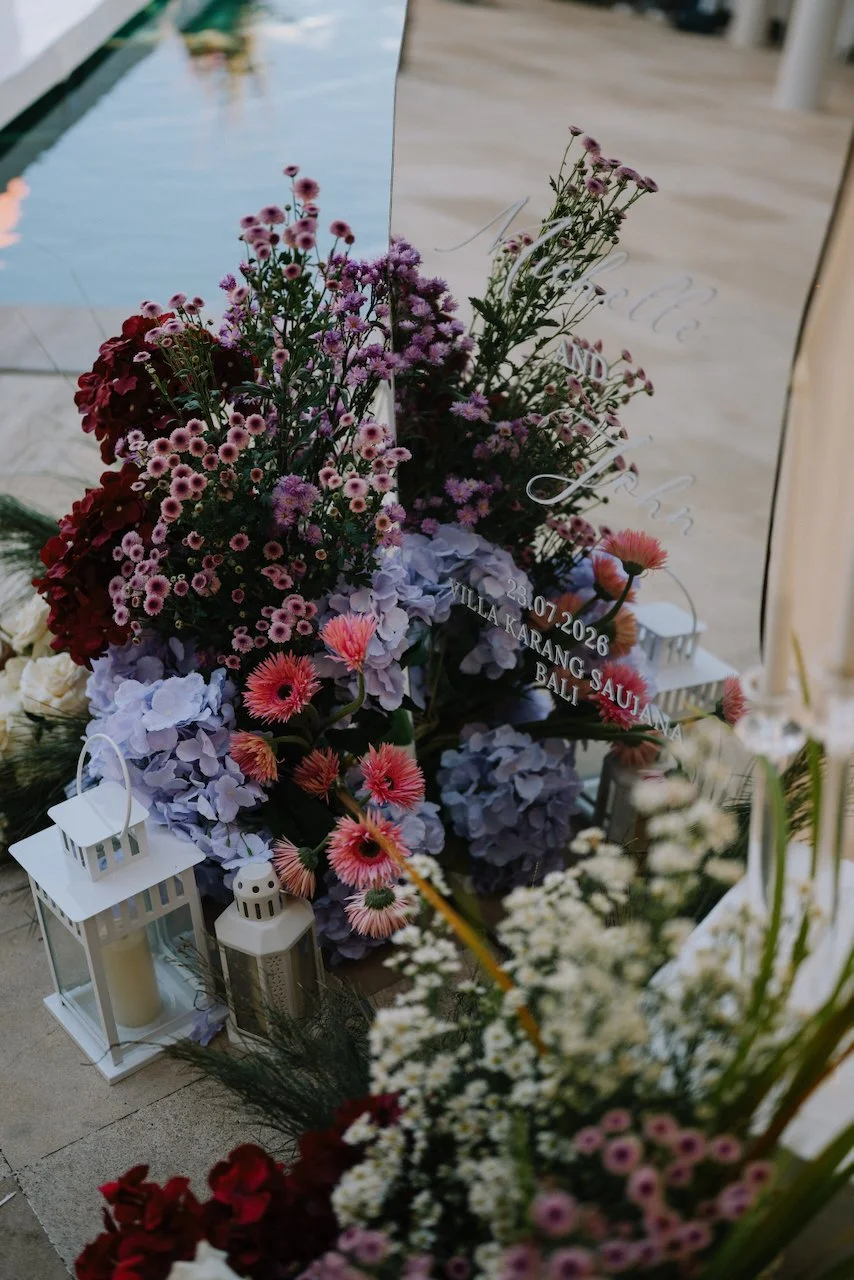 Vibrant purple and red floral arrangements decorating a Karang Saujana villa