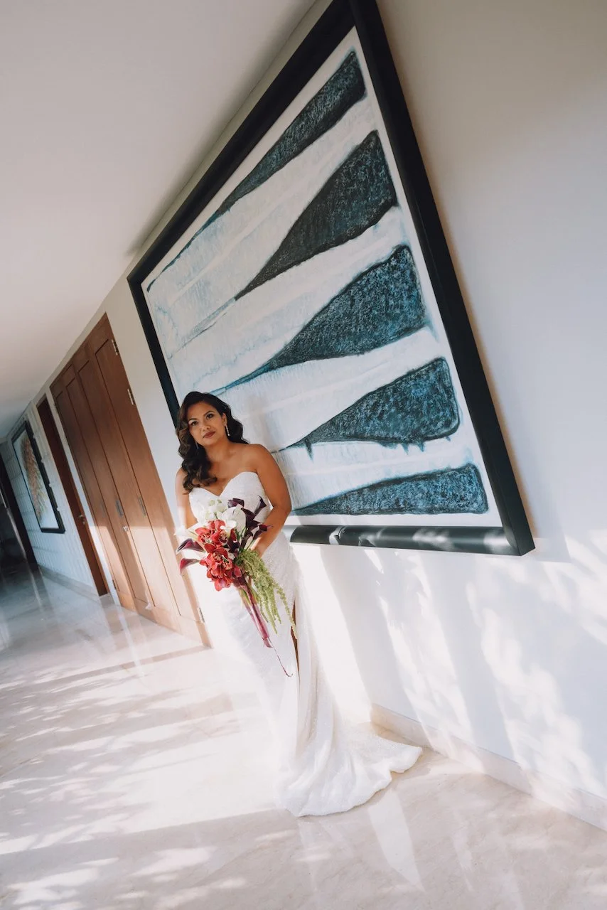 Bride Michelle standing by a large modern artwork at Karang Saujana Bali