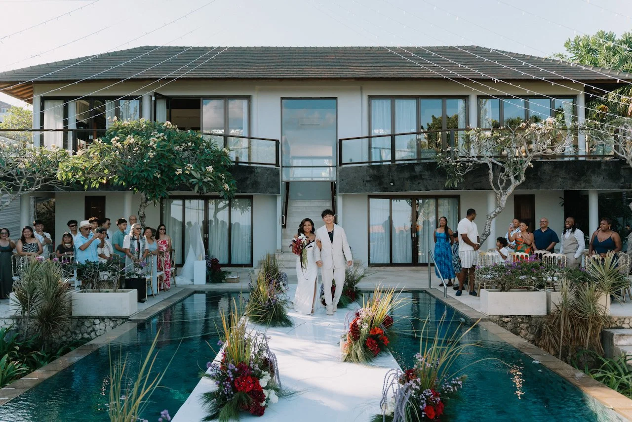 Wide view of guests gathered around a pool stage at a luxury Bali villa