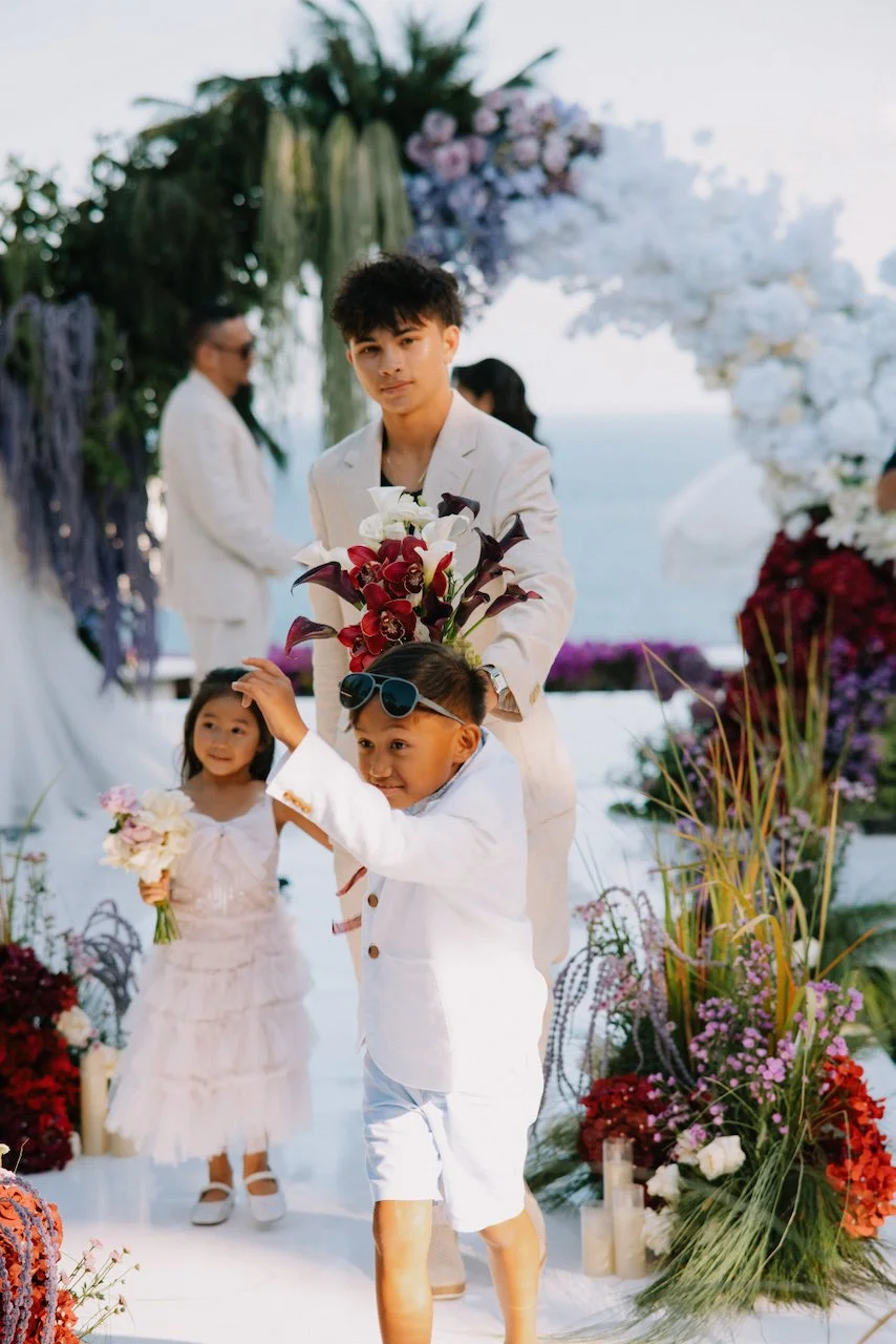Flower girl and ring bearer walking down the clear acrylic aisle