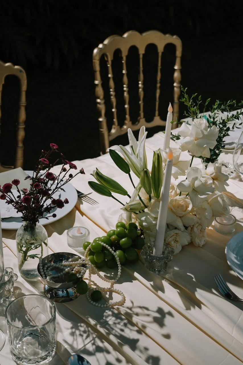 Elegant outdoor dining setup with gold chairs and crisp white linens