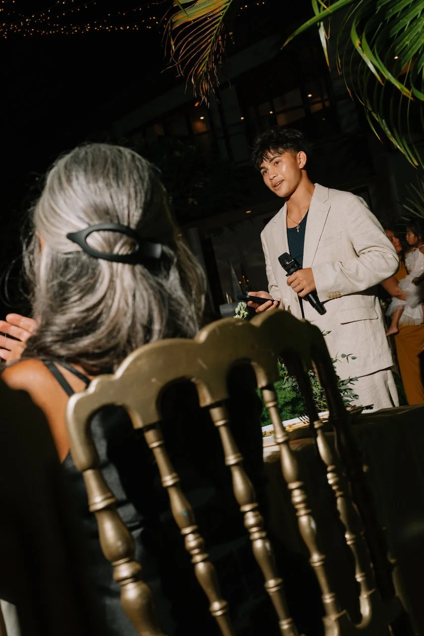 Guest delivering a speech at an outdoor villa wedding reception
