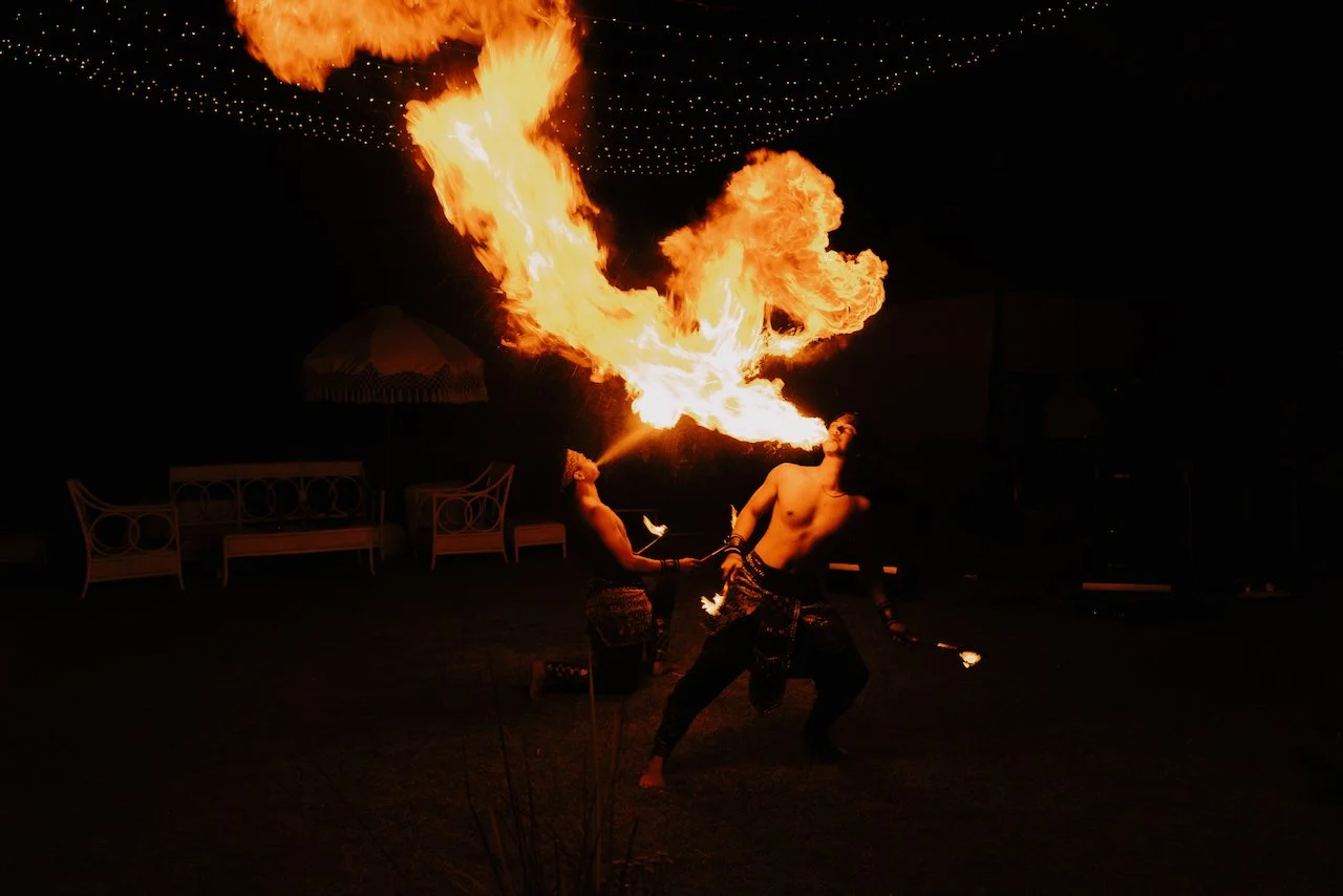 Fire dancer performing a thrilling night show for wedding guests in Bali