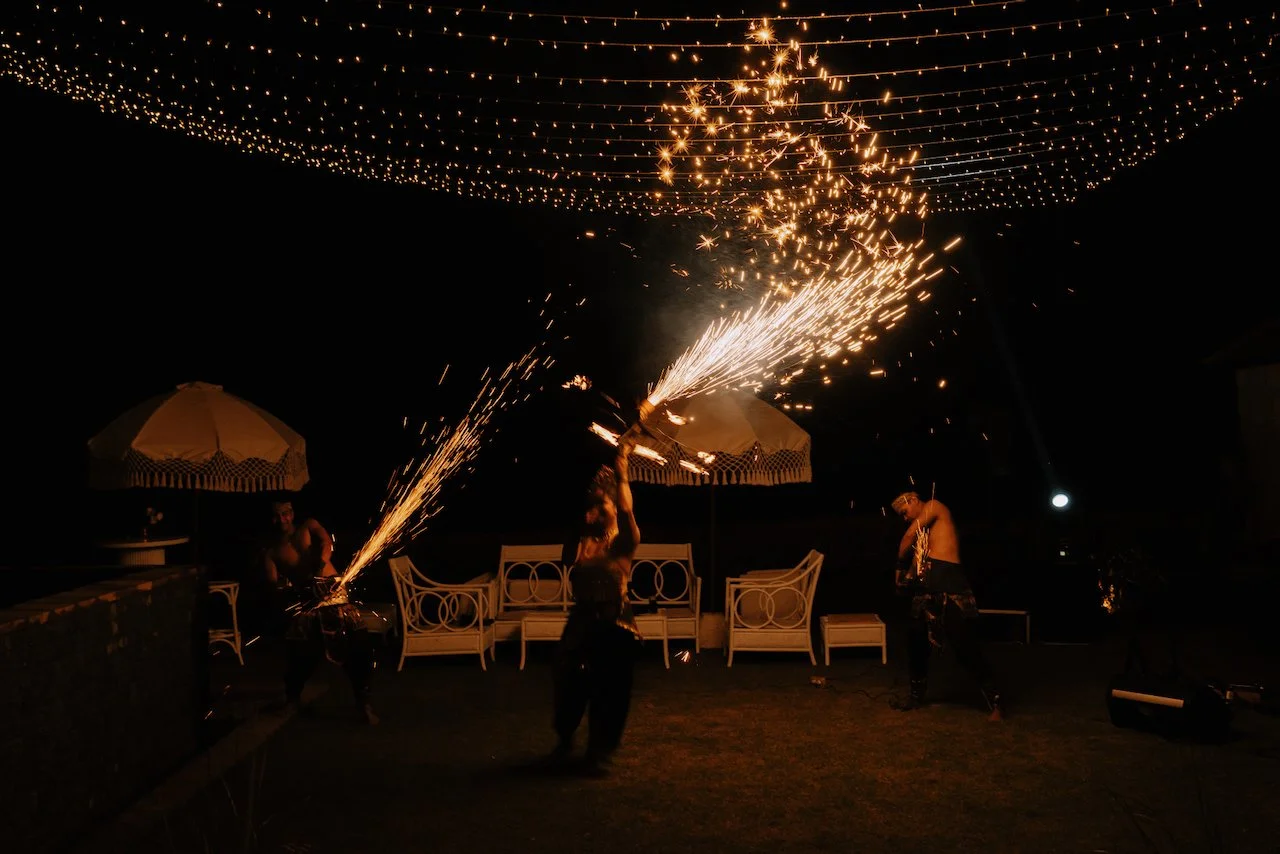 Entertainer spinning sparks during a night time performance at Karang Saujana