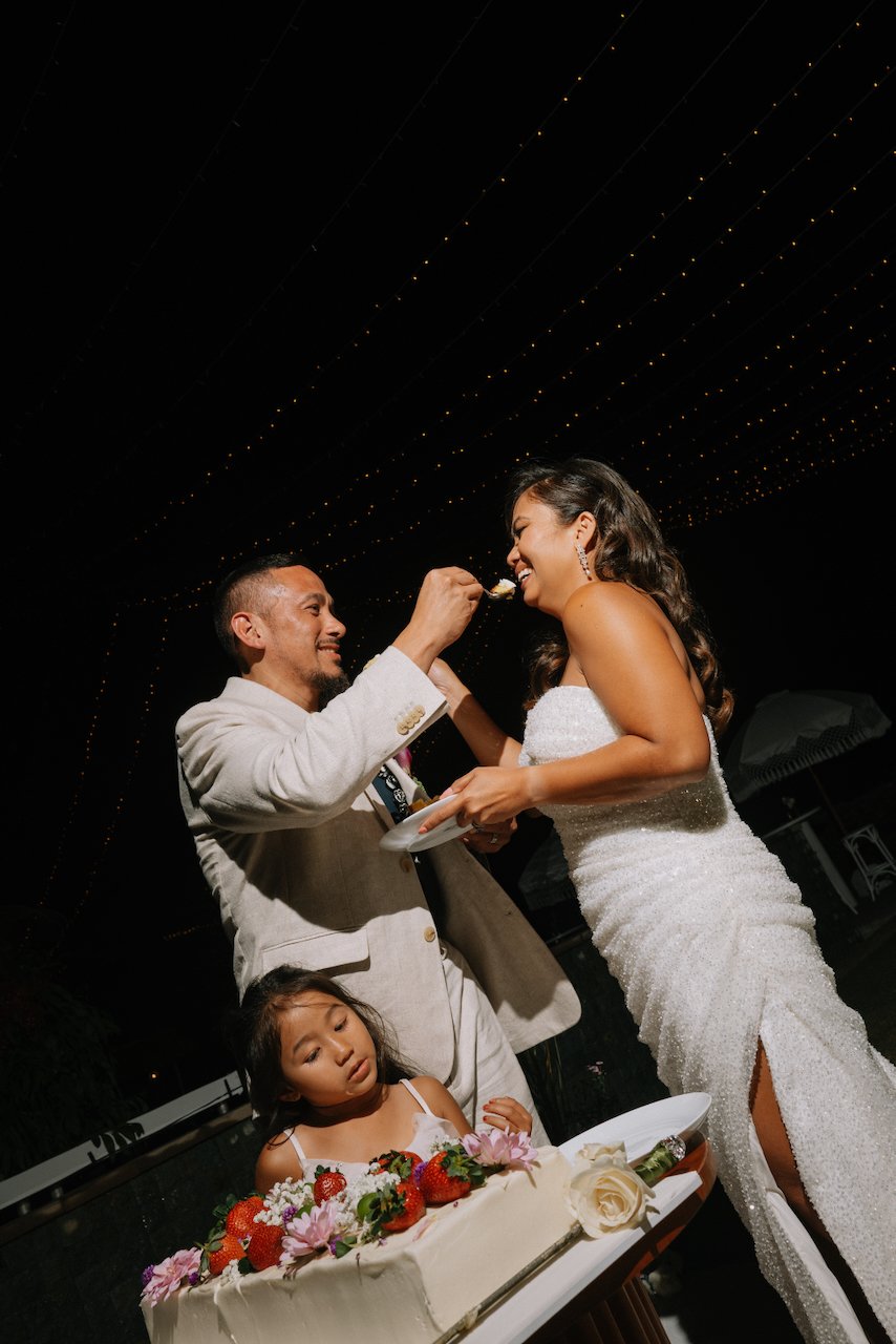 Michelle and John feeding each other cake during their reception