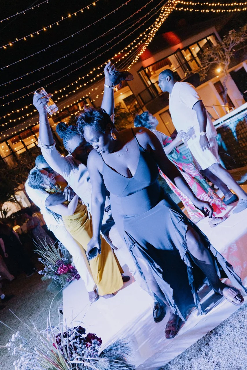 Guests having fun dancing on a white dance floor at a Bali villa party