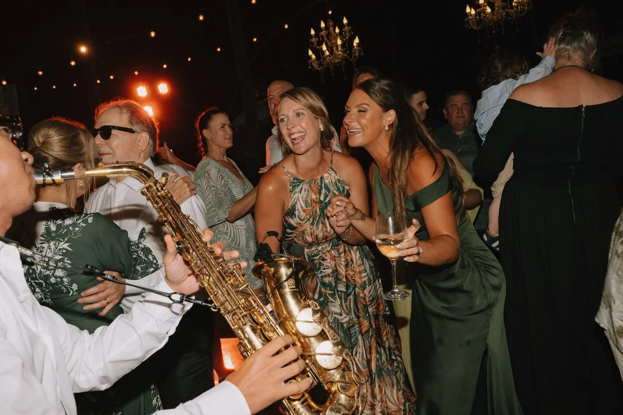 Saxophone player performing on the dance floor during a Bali wedding reception