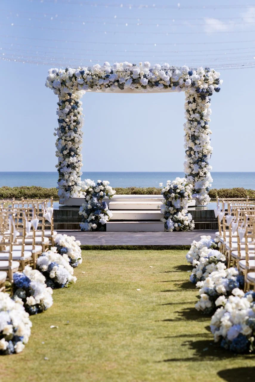 Floral wedding ceremony arch overlooking the gardens