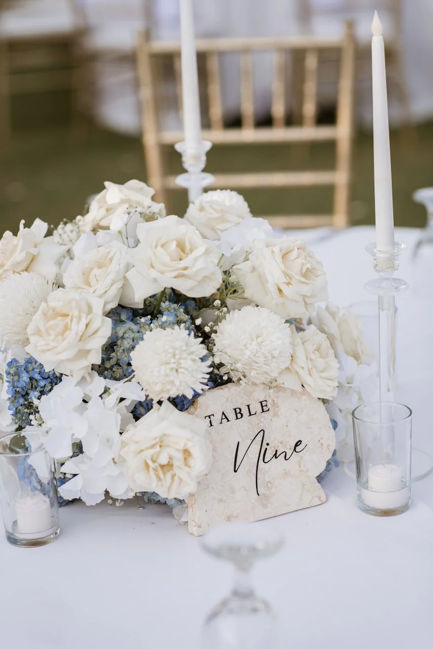White floral table arrangement with Kelsey and Jason place card