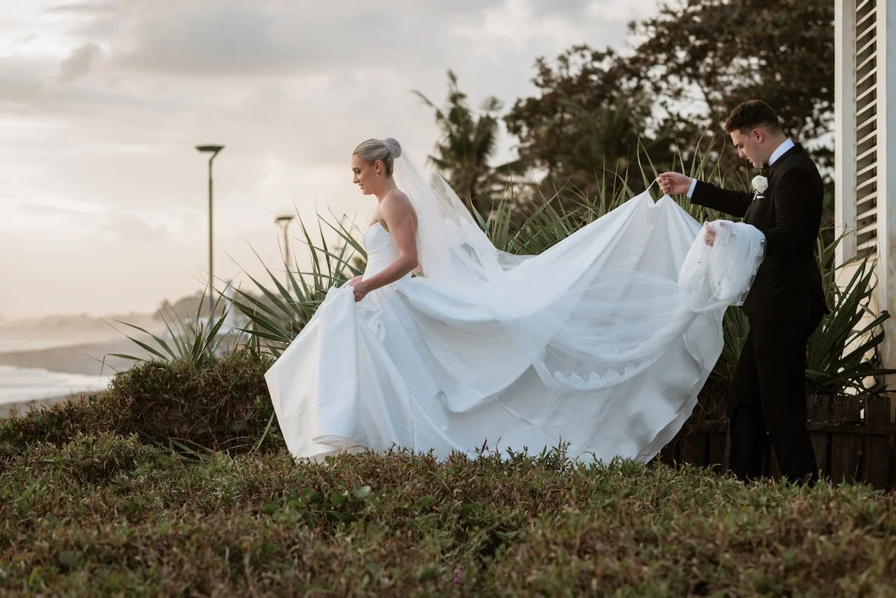 Kelsey and Jason walking together beside the ocean