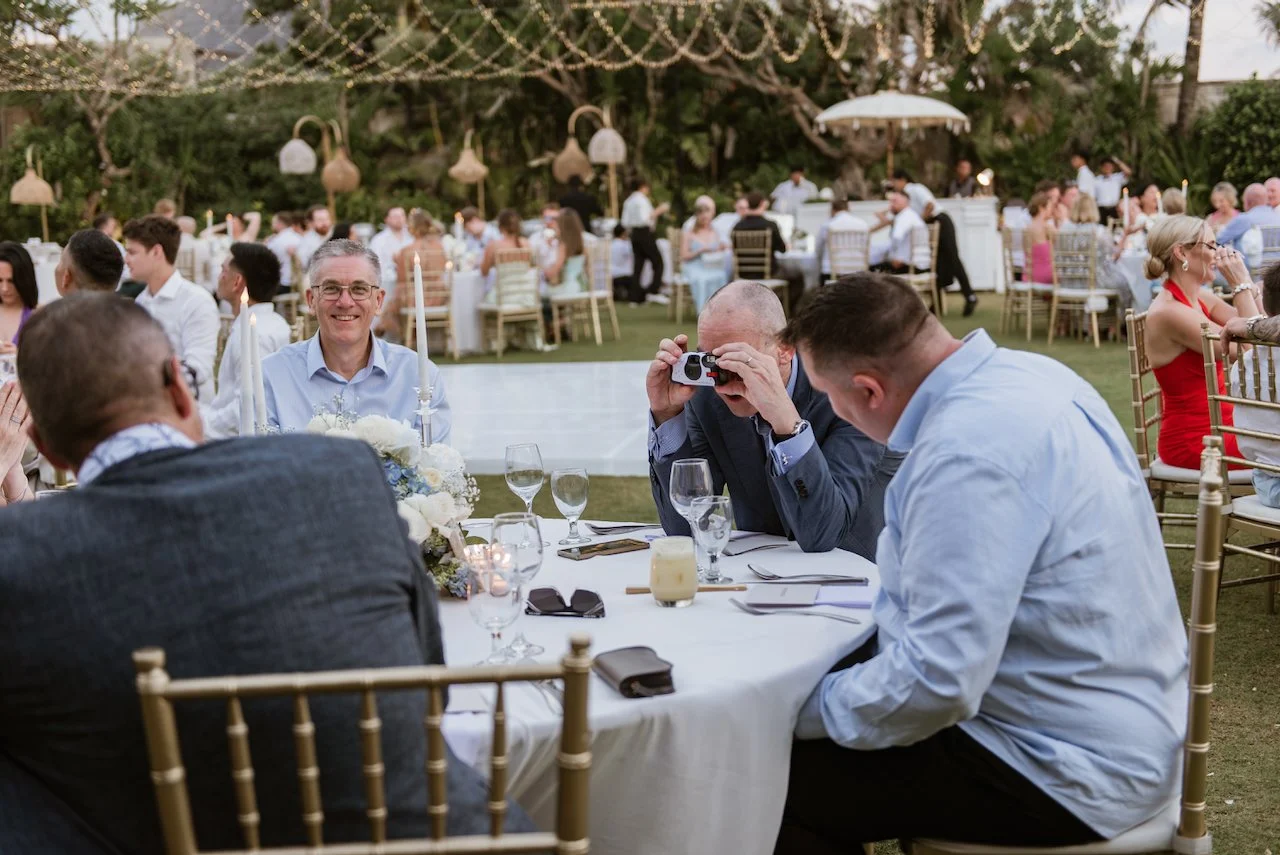 Wedding guests enjoying dinner outdoors