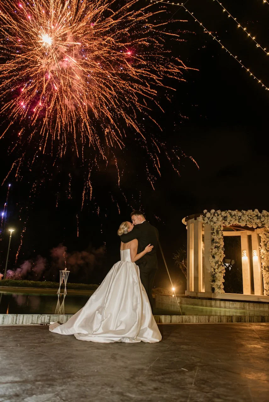 Bride and groom watching fireworks during the wedding celebration
