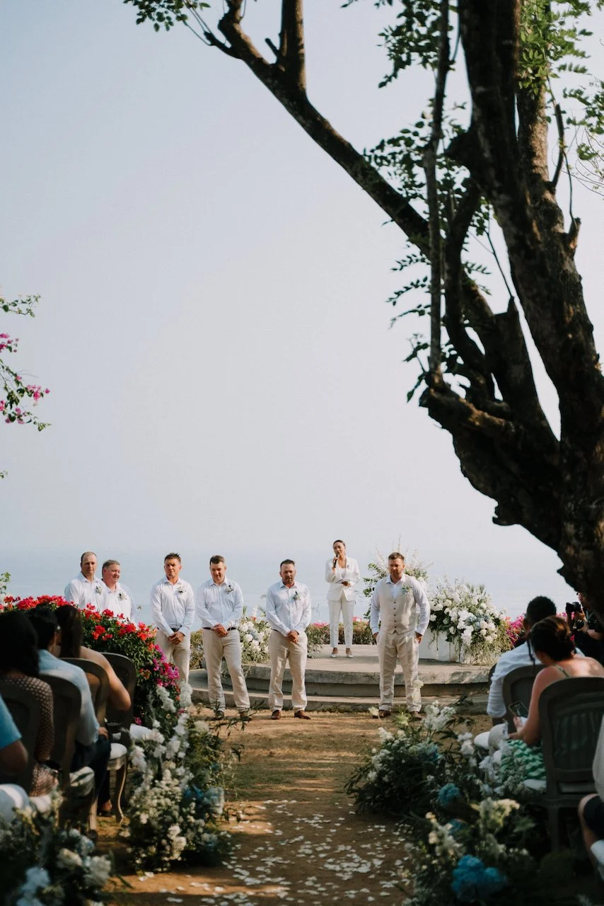 Groomsmen and the celebrant waiting at the end of the aisle before the ceremony at Wonderland, Uluwatu
