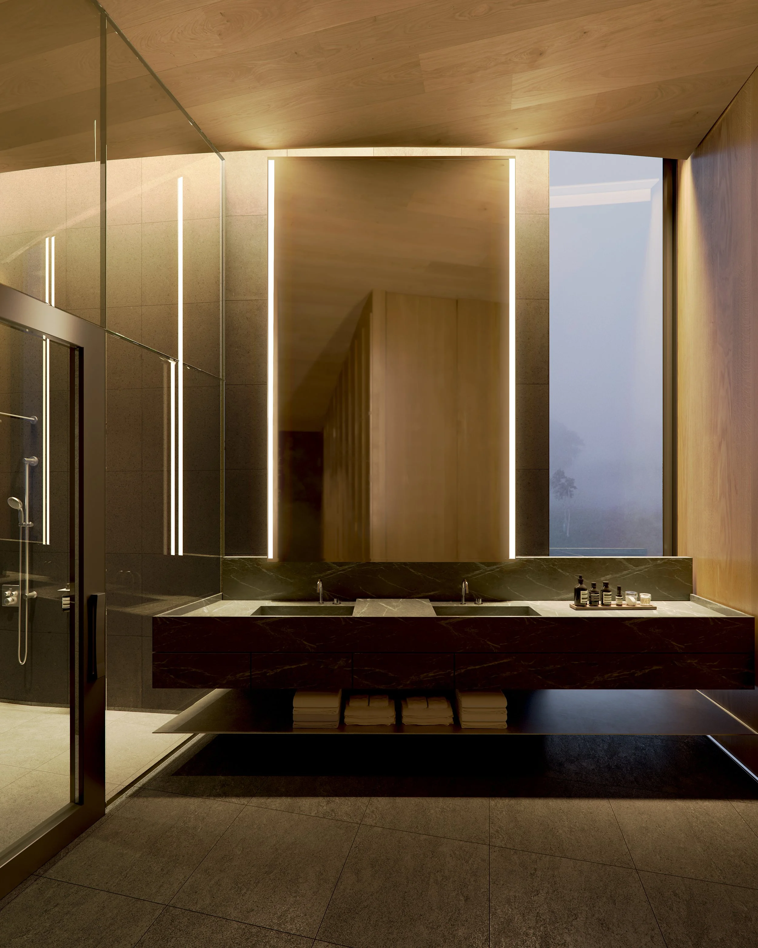 Modern bathroom with black marble double sinks, large mirror, wood panel walls, reflective surfaces, and towels stored beneath the sinks.