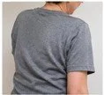 Close-up of a person wearing a gray t-shirt, seen from the back.