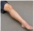 A person holding their foot with their hand