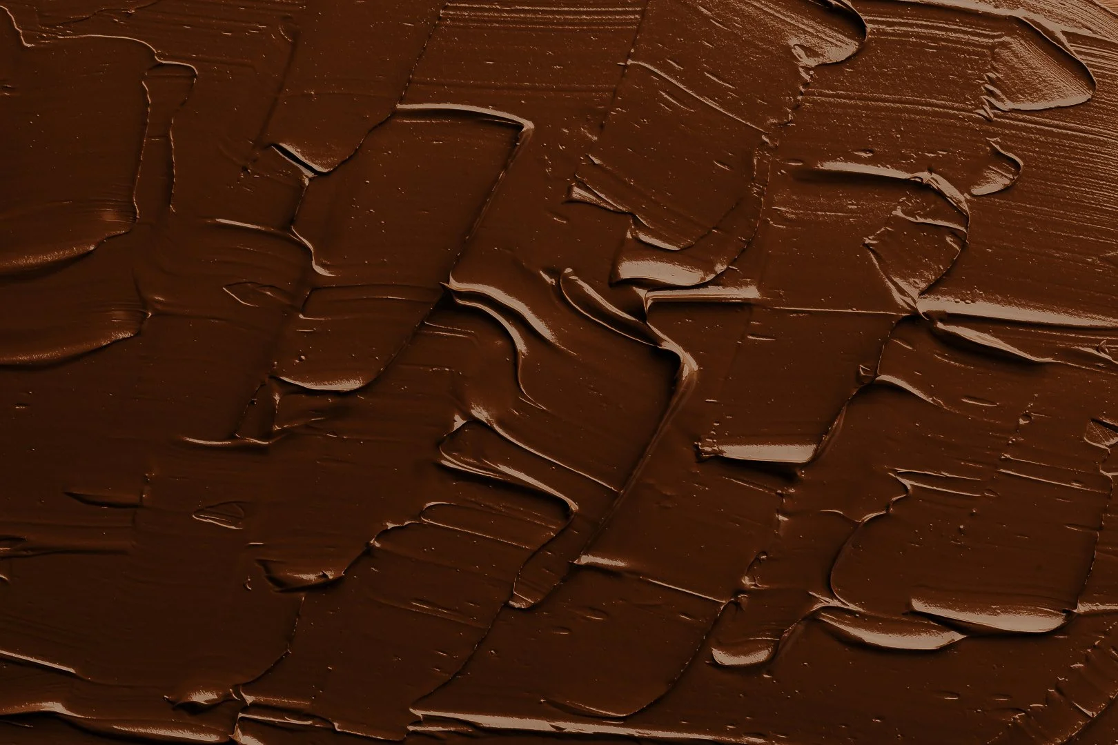 Abstract texture of chocolate brown clay face mask.