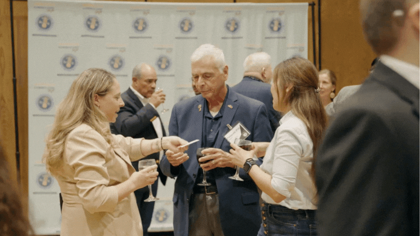 Professional networking and strategic partnership at the Garden City Chamber Connect event hosted at Adelphi University, captured by Bigode Inc
