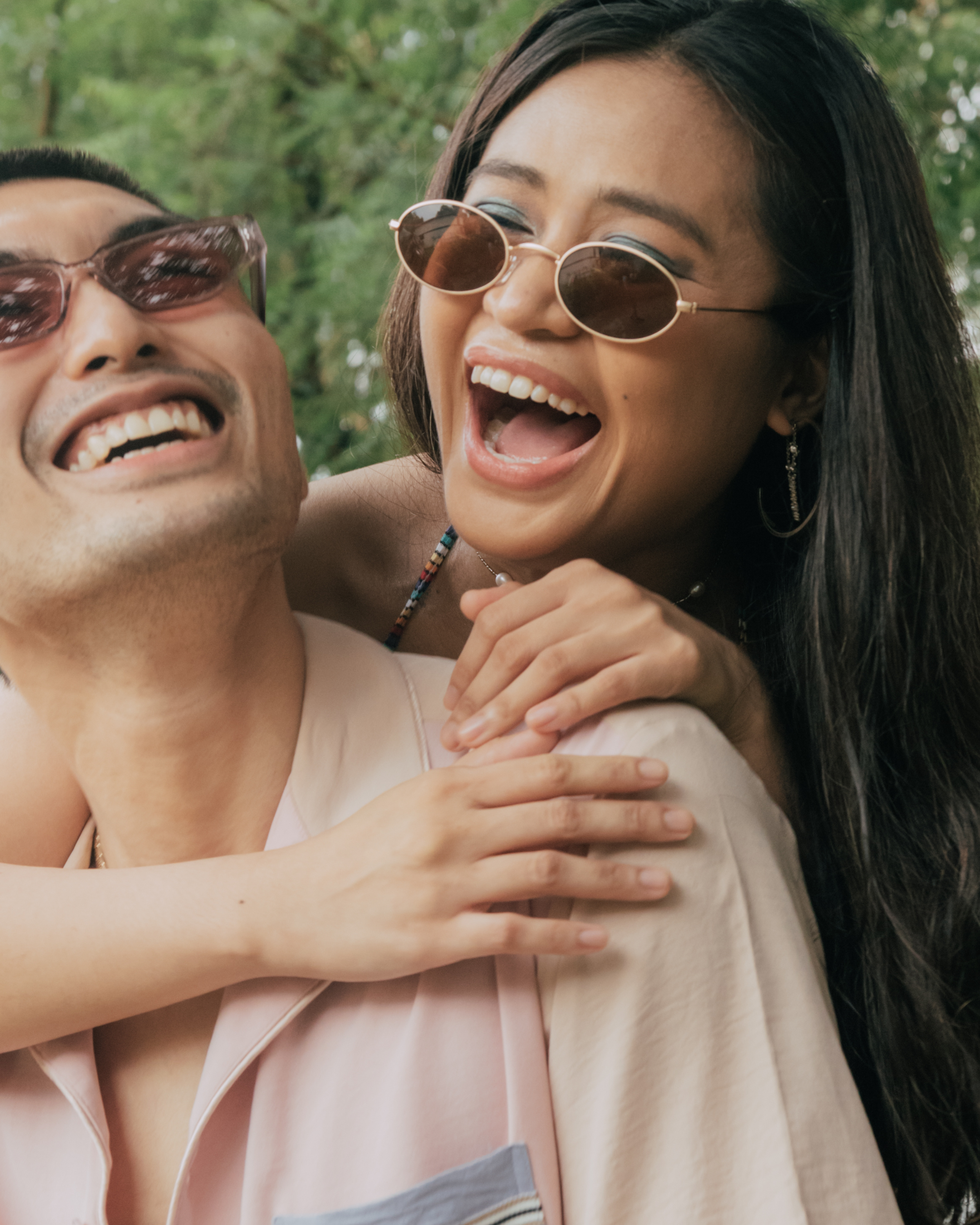 Straight Asian couple hugging and laughing