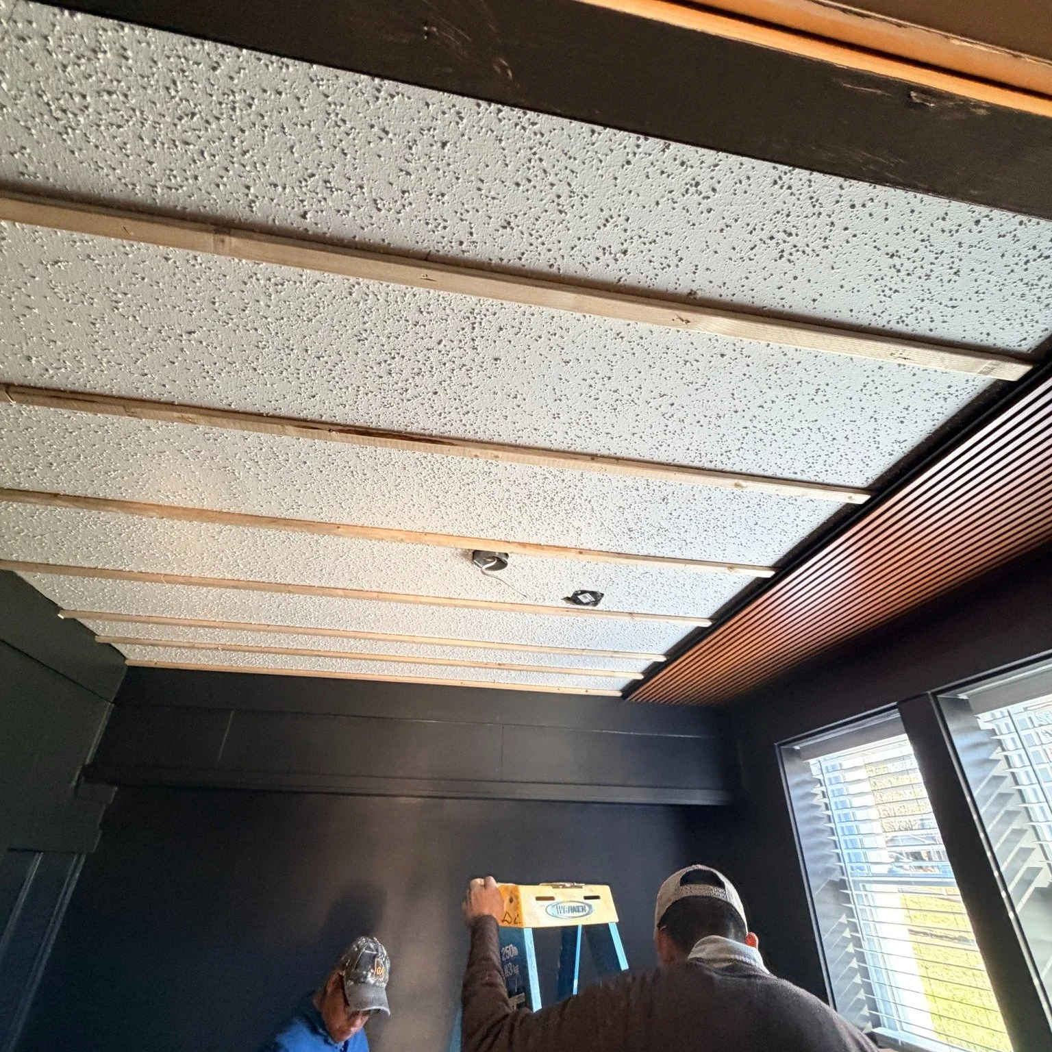 The ceiling changed everything. 🔥

We transformed this personal office with a fluted wood acoustic ceiling- adding warmth, dimension, and modern character while helping create a more comfortable, focused workspace.

The natural wood tones contrast b