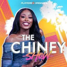 Promotional poster for The Chinney Show featuring a smiling woman with long black hair, wearing an off-shoulder blue top, with a colorful, cityscape background and clouds.