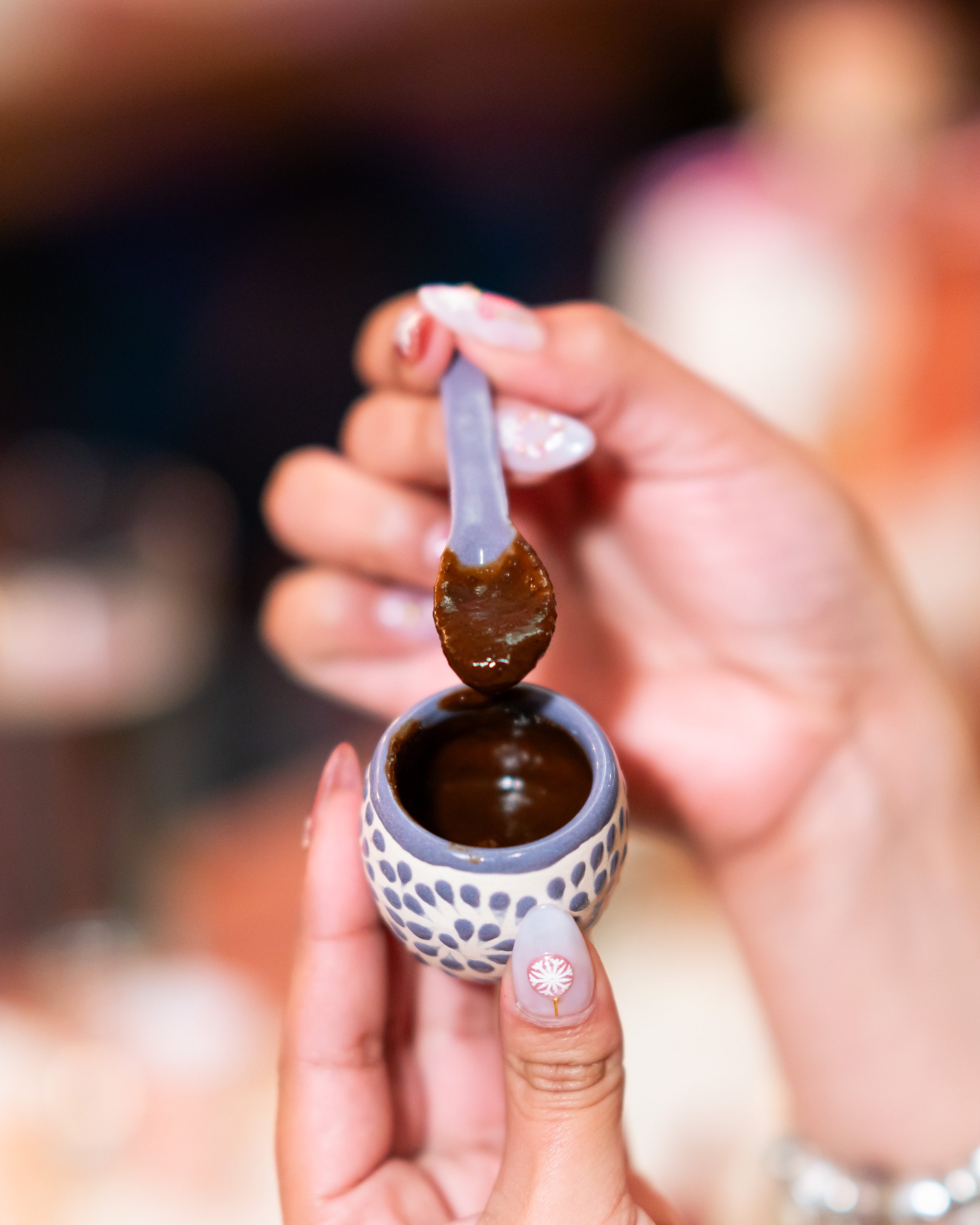 Traditional Oaxacan mole on a handcrafted spoon served during Mezcal y Mole tasting