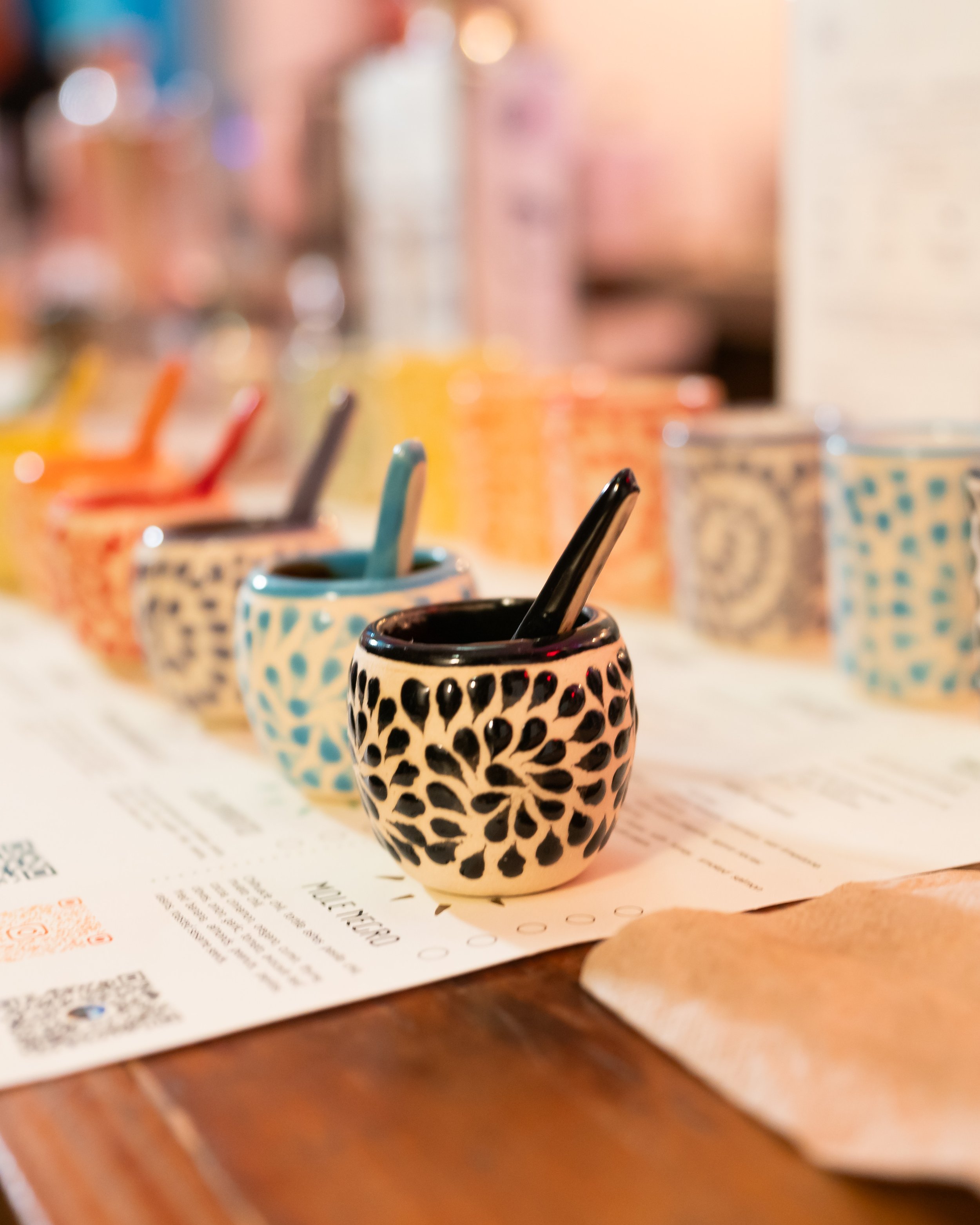 Artisanal mezcal with traditional mole served in Oaxacan clay copitas at Origin Explorers tasting