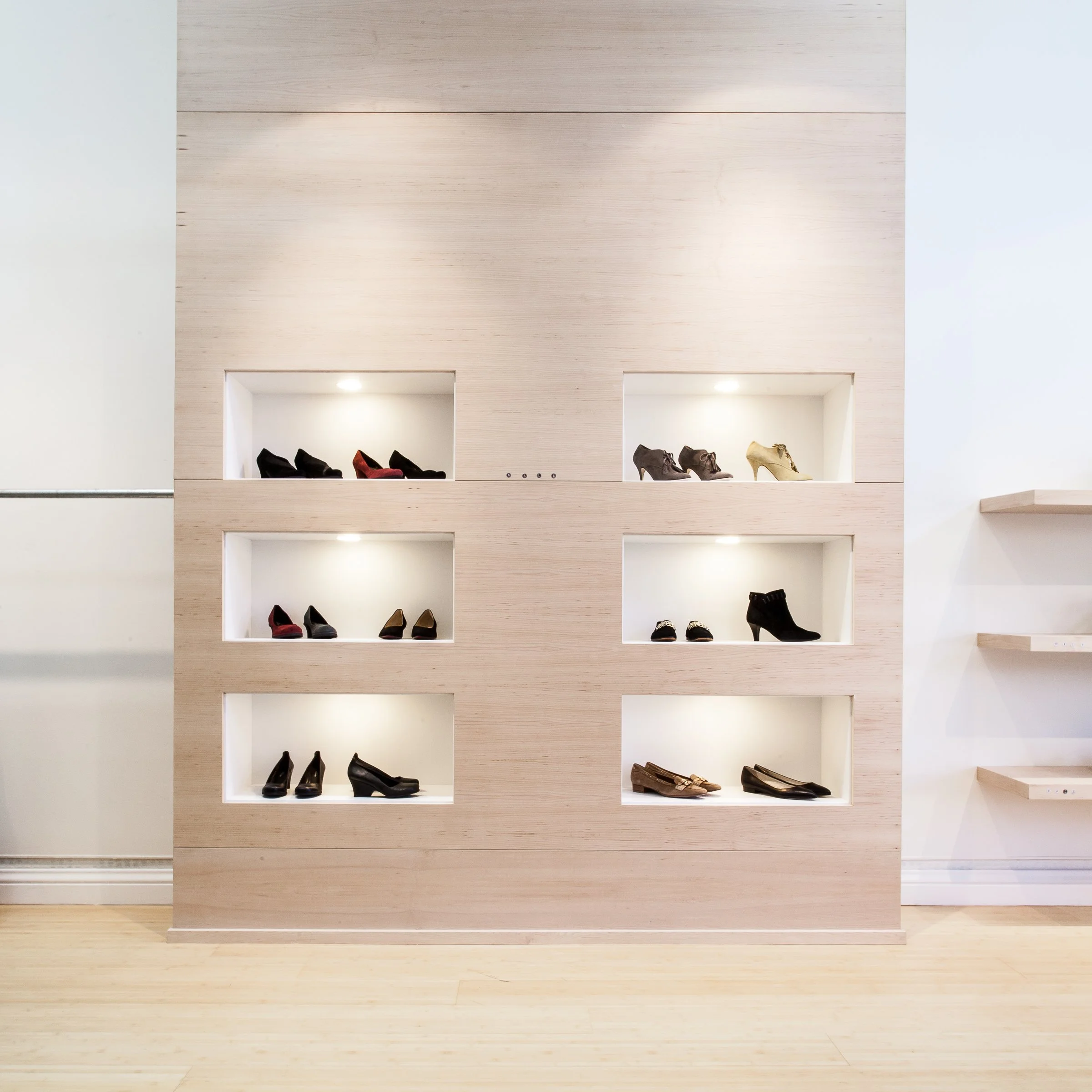 Display of women's shoes in cubby shelves in a store.