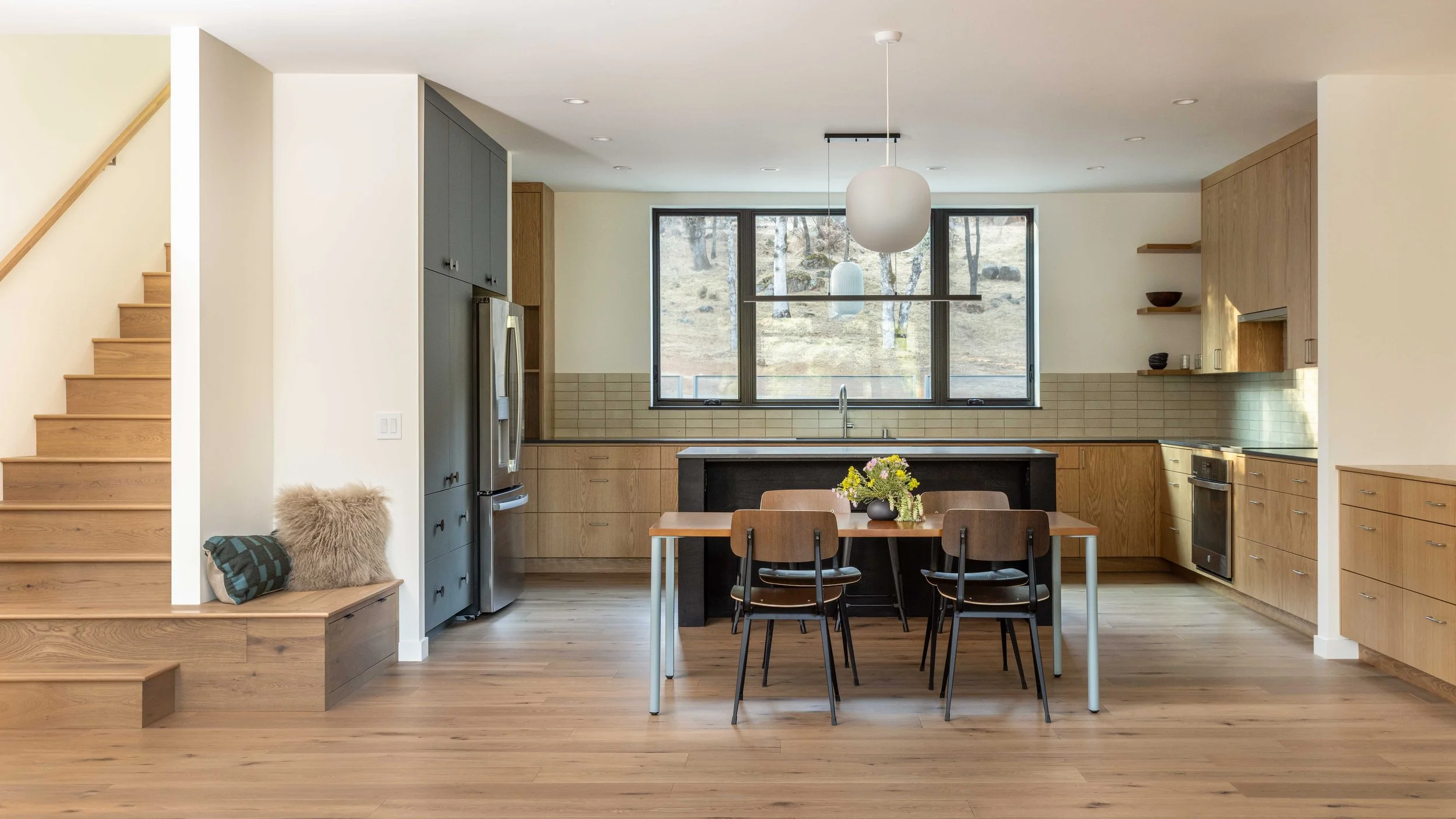 Modern kitchen with stairs wrapping around to create a bench