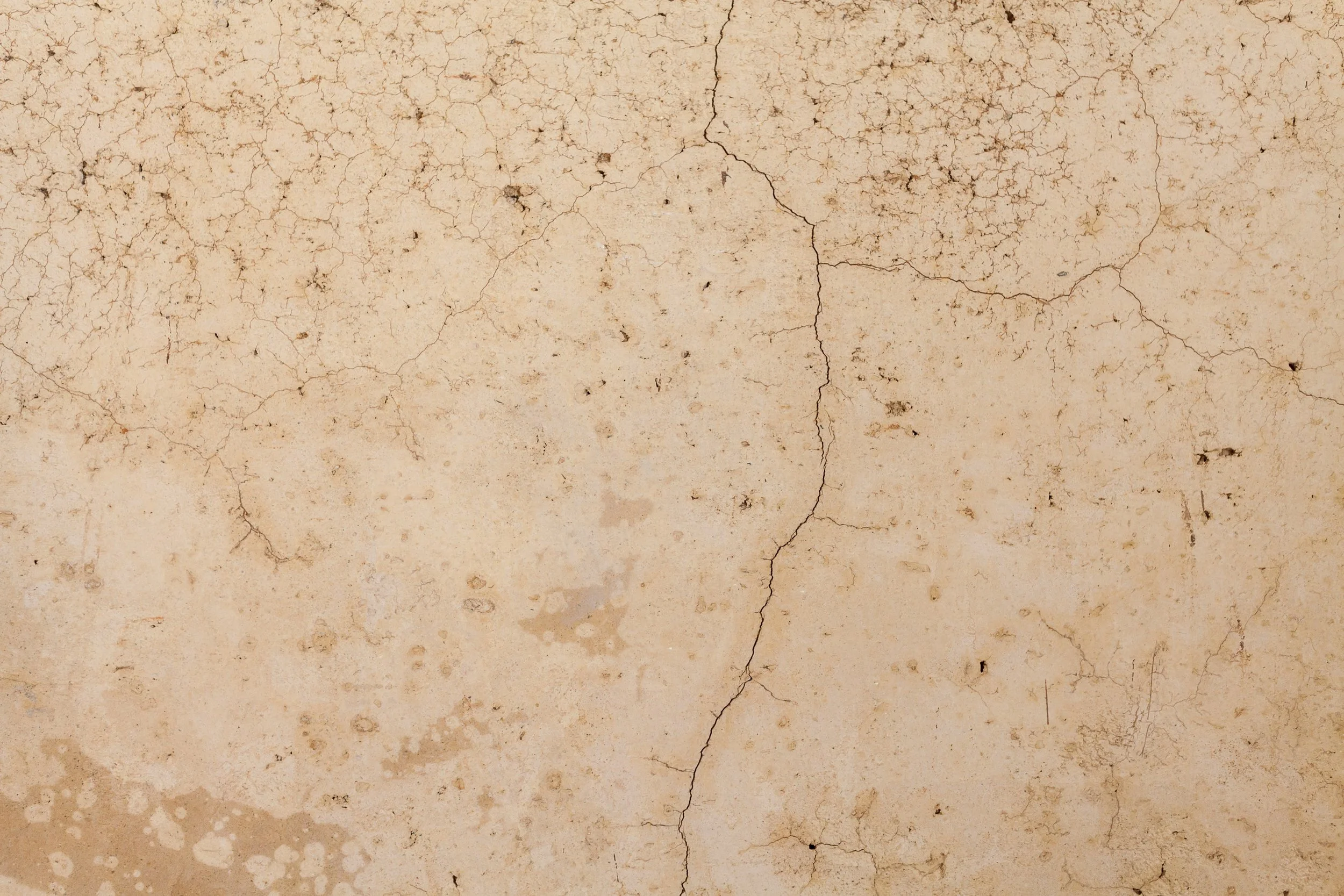 Cracked beige surface texture with fine lines