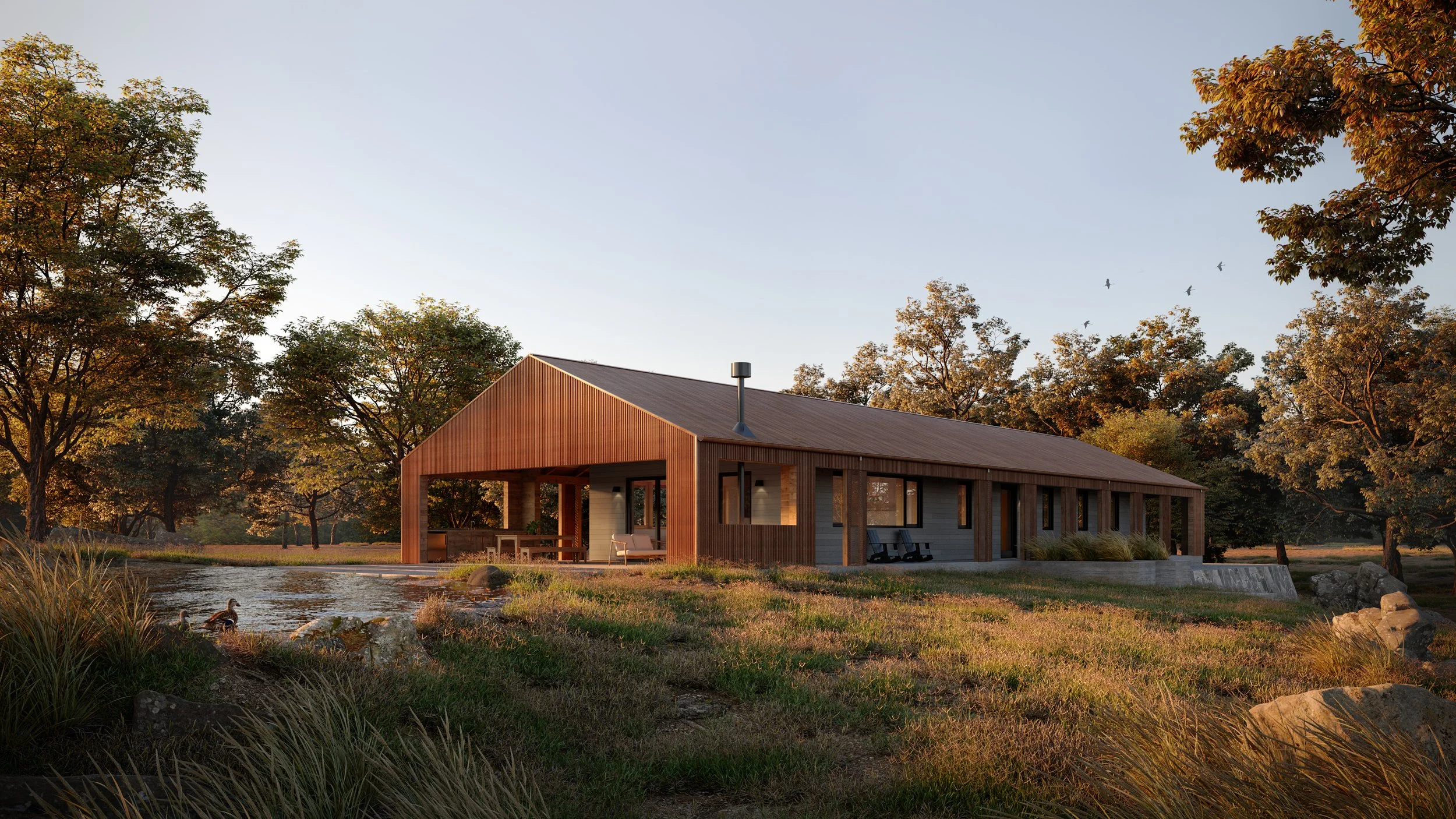 A modern house made of wood and metal with large windows, situated near a pond, surrounded by trees with autumn leaves and a duck in the water, during sunset.