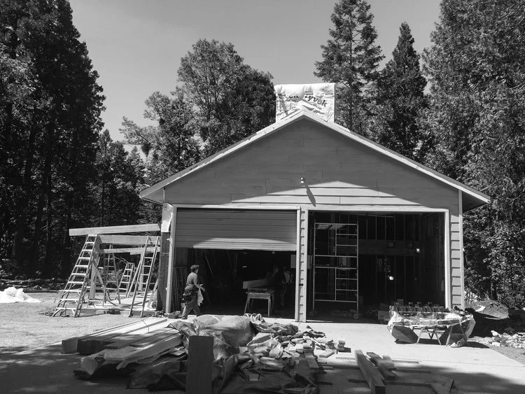 Construction of a garage with ladders and materials outside