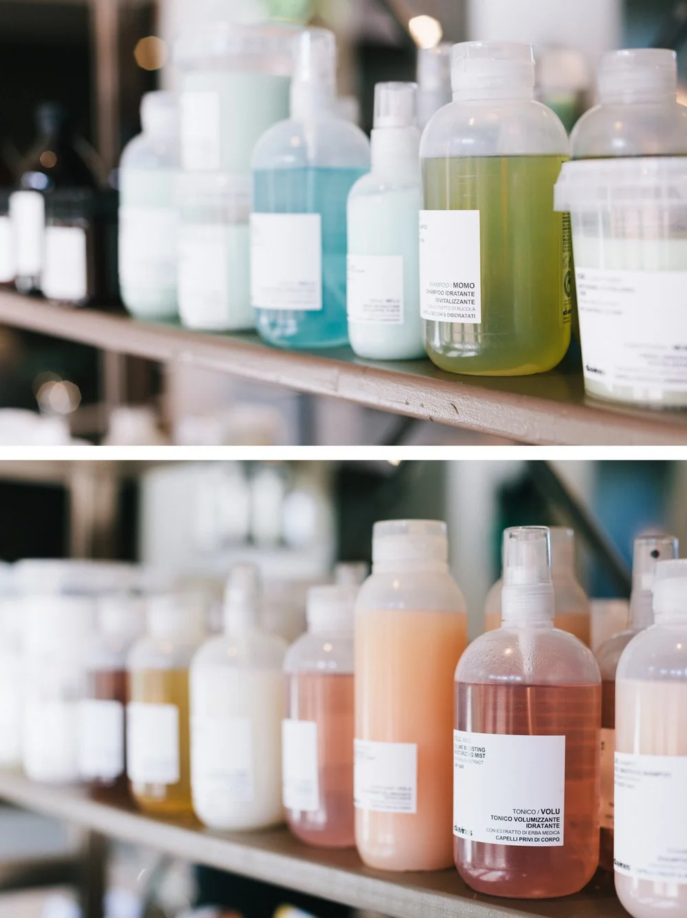 Various bottles of hair care products on a shelf, different colors and labels.