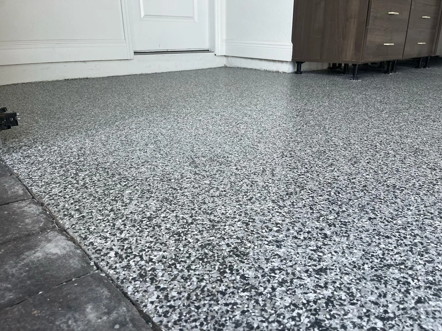 Garage flake flooring system install with Torginol 1/4 inch flake and high performance urethane seal coat. #garageepoxyfloor #garageflakefloor #epoxyfloor