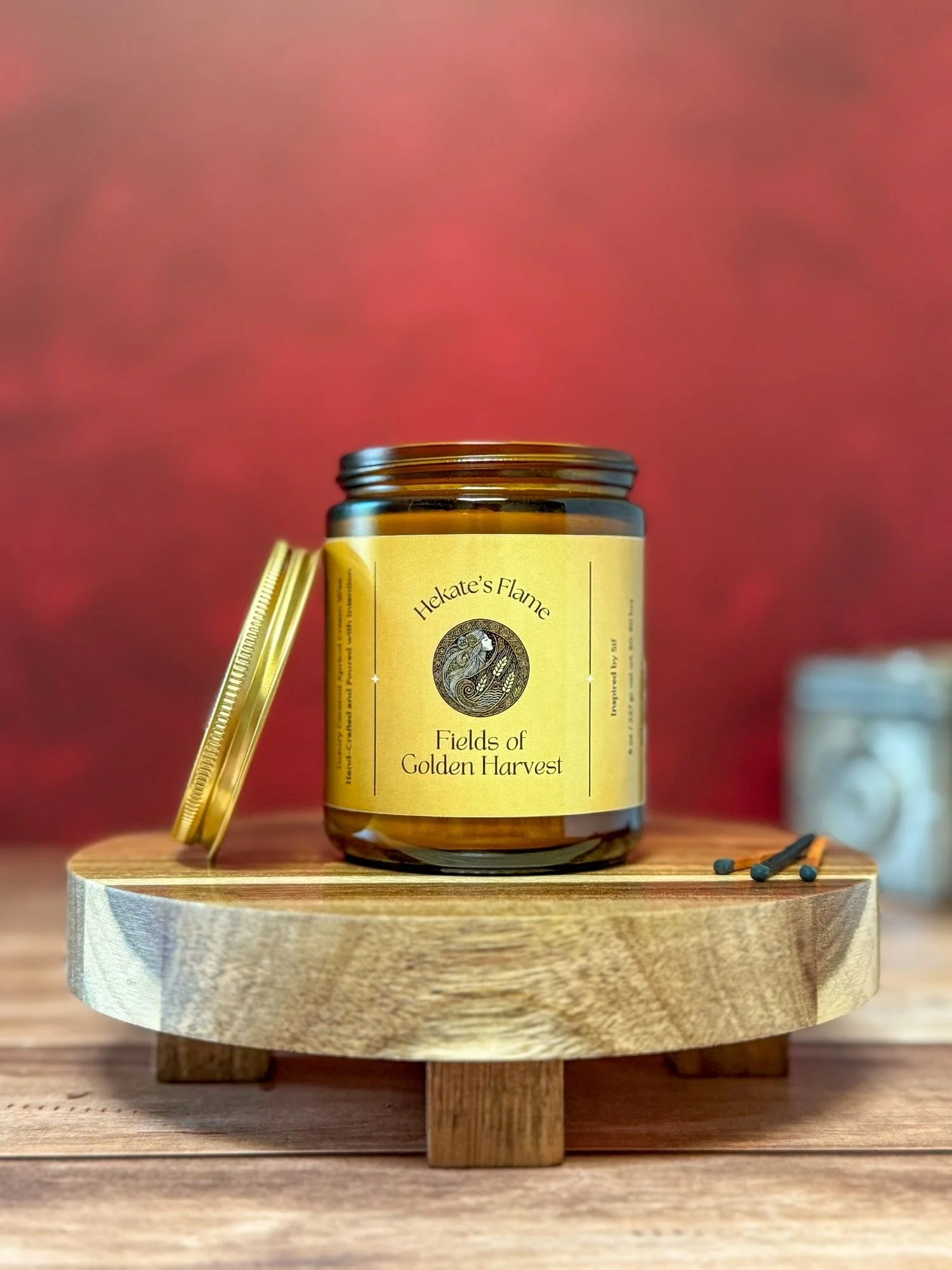 Luxury Sif goddess candle in amber glass with gold lid – myth-inspired coconut apricot wax candle, hand poured.