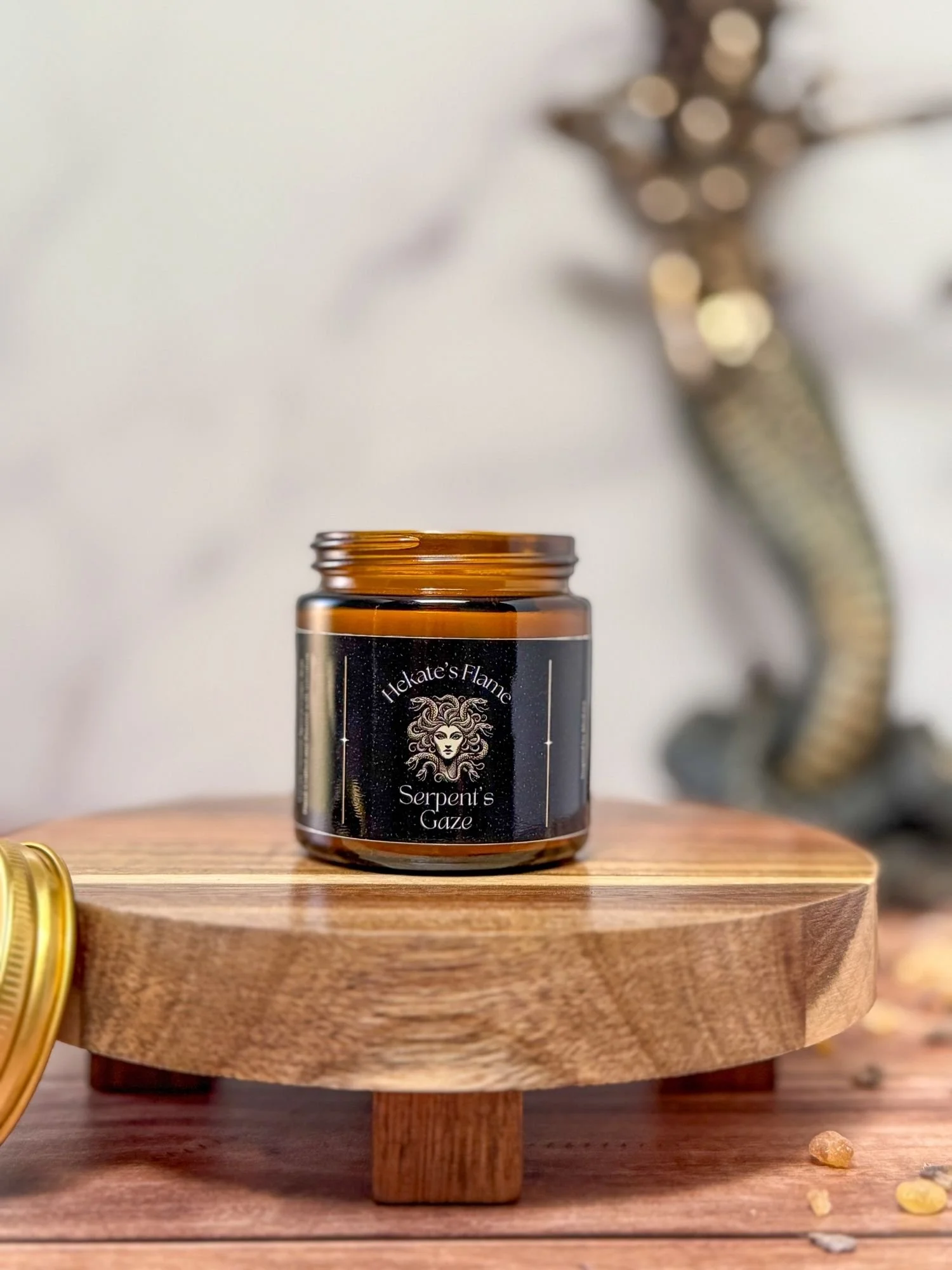 Open amber jar Greek mythology candle with Medusa design, hand poured coconut apricot wax, eco-conscious luxury candle.