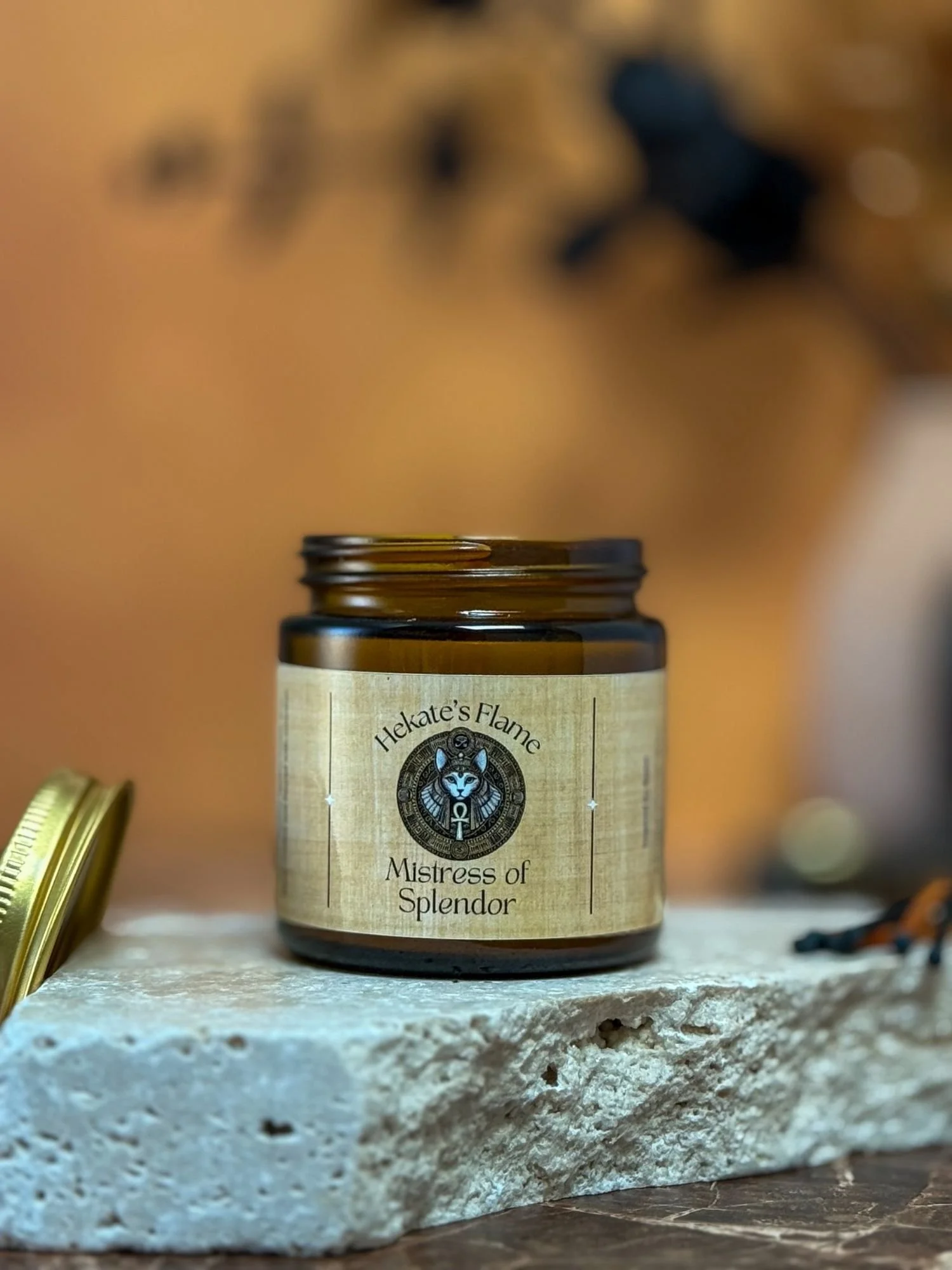 Bastet candle in amber glass with cork lid, honoring the Egyptian goddess of protection and splendor.