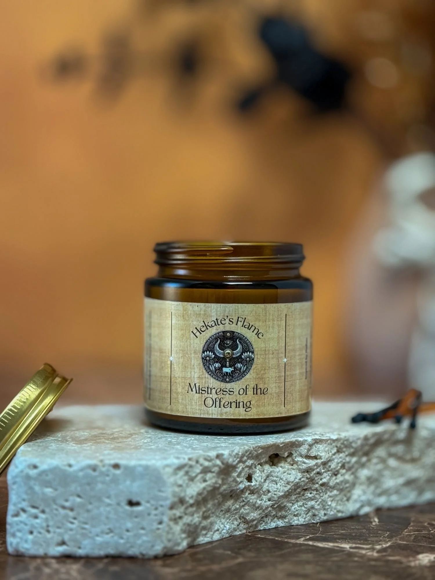 Egyptian goddess Hathor inspired candle in amber glass jar, handcrafted coconut apricot wax with wooden wick.