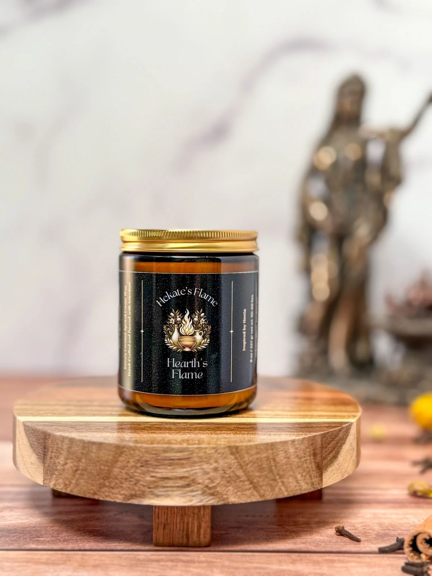 Handmade Greek mythology candle, Hearth’s Flame, in amber glass with gold lid, luxury eco-conscious coconut apricot wax.