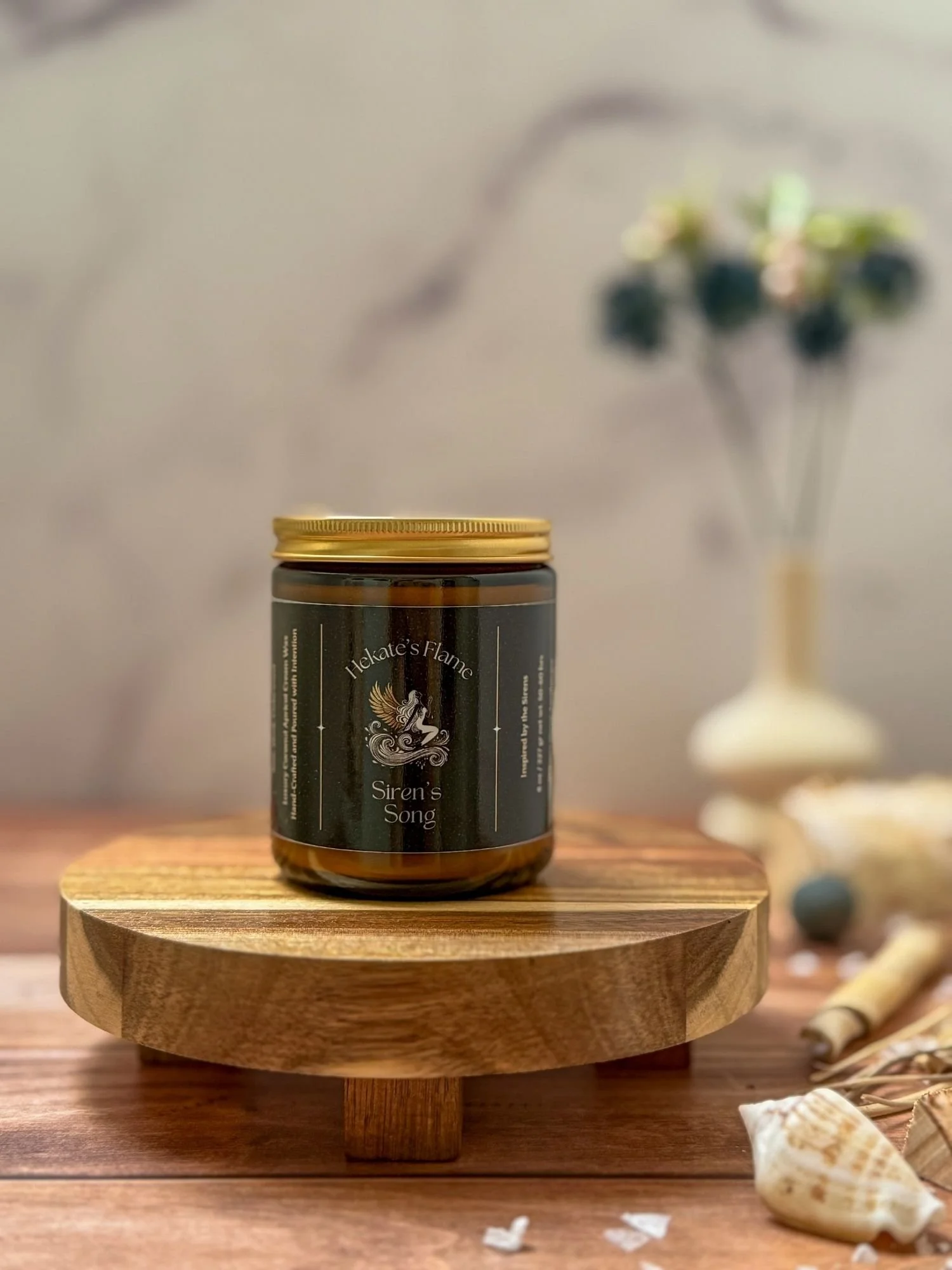 Amber glass Siren’s Song candle with gold metal lid, myth-inspired coconut apricot wax luxury candle, handcrafted and hand-poured.